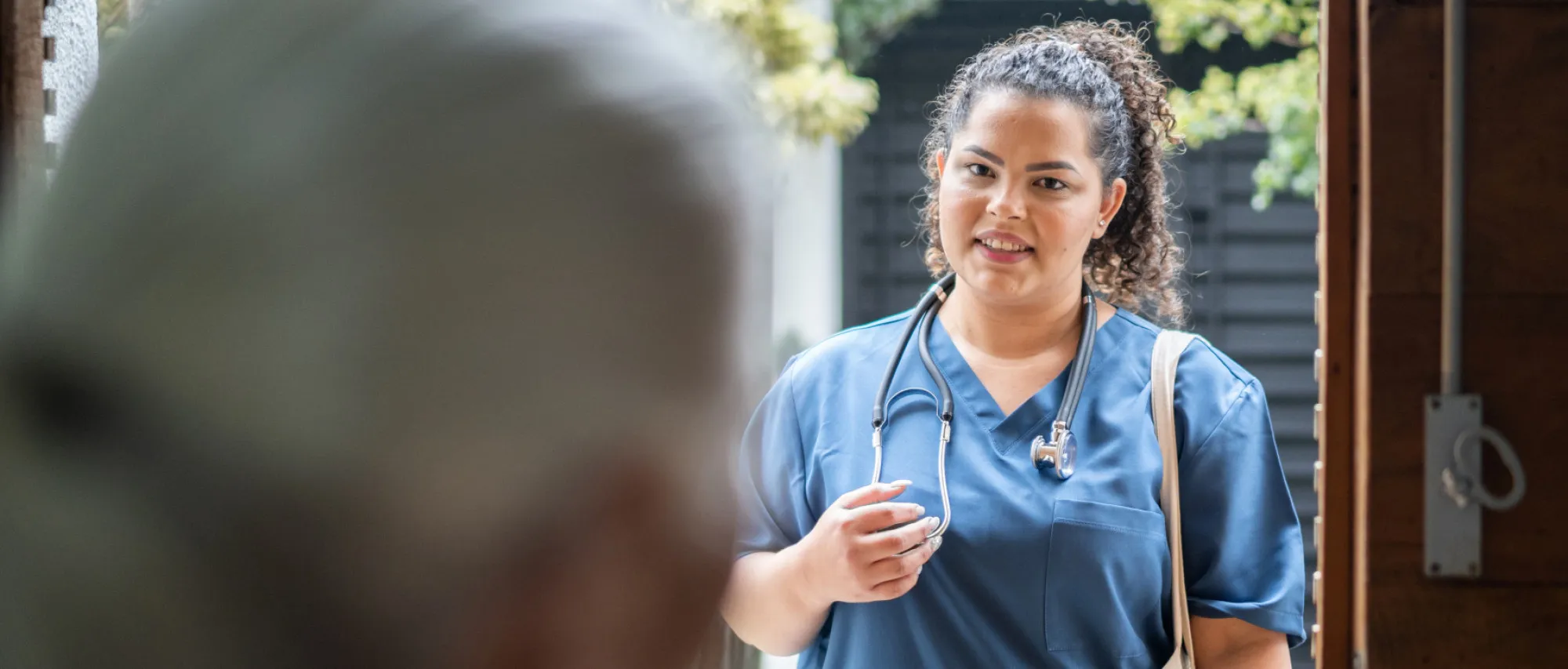 Nurse visiting patient at their home