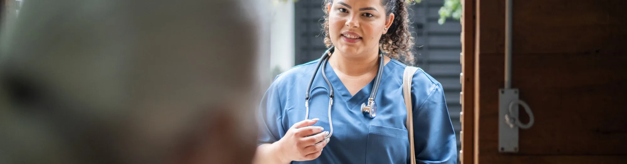 Nurse visiting patient at their home