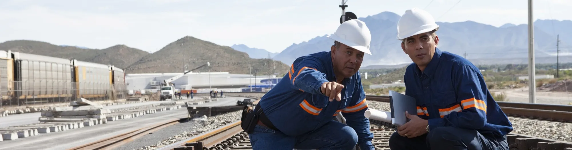 Two male engineers at railroad construction