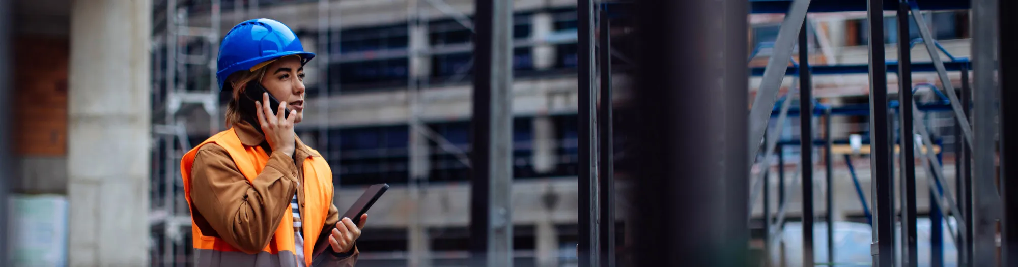 Female worker on the phone at a construction site