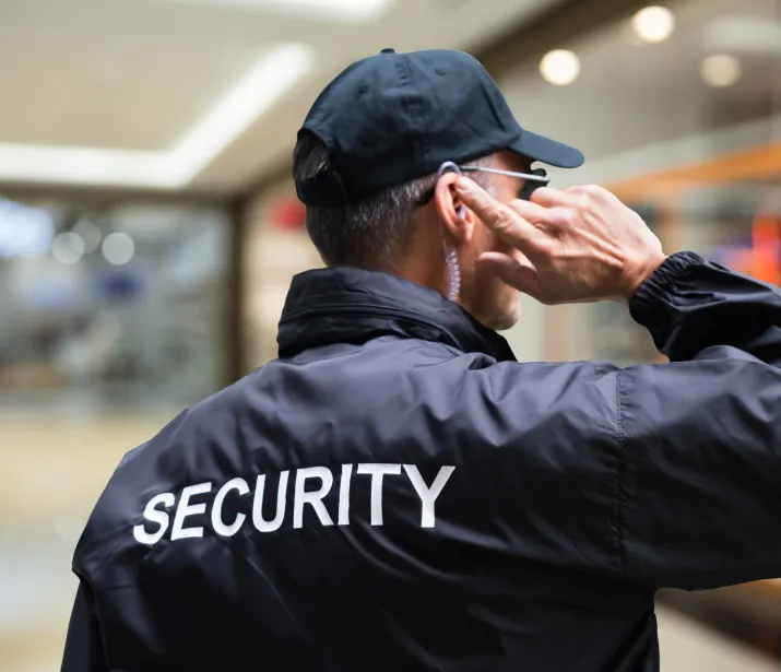 Male Security Officer Listening To Earpiece