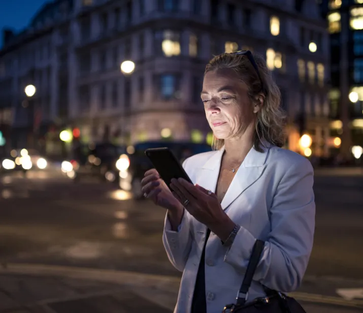 Business woman using phone in London