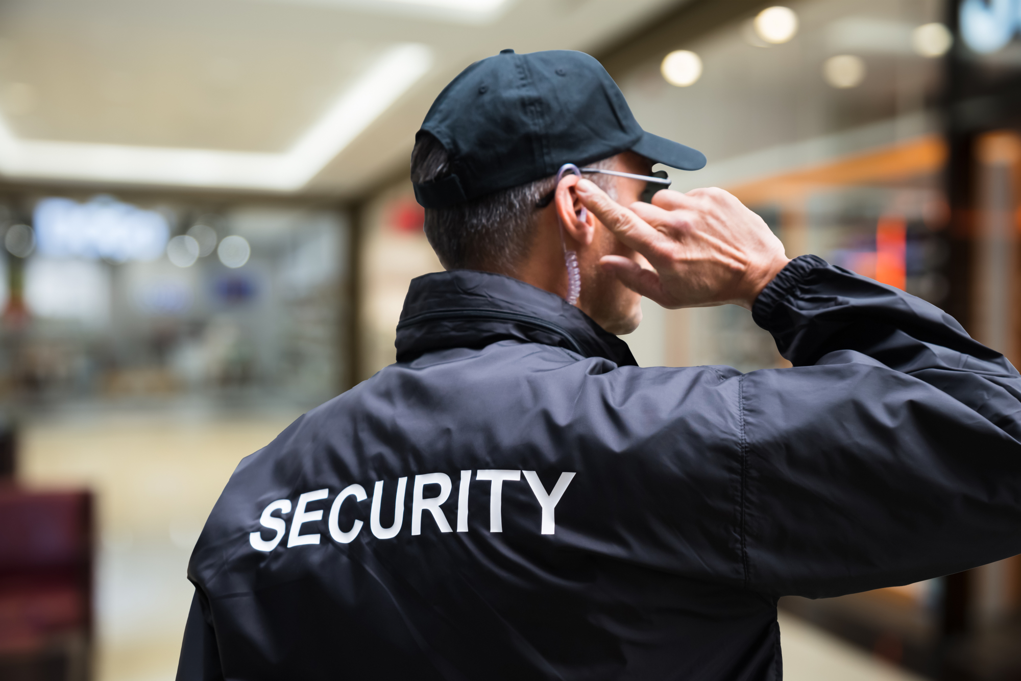 Male Security Officer Listening To Earpiece