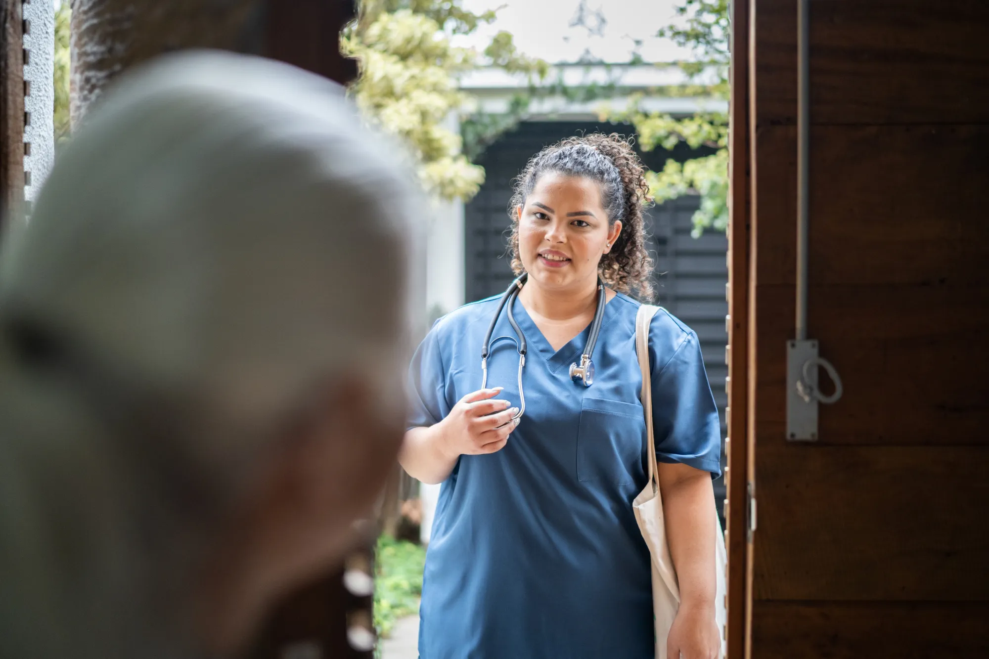 Nurse visiting patient at their home