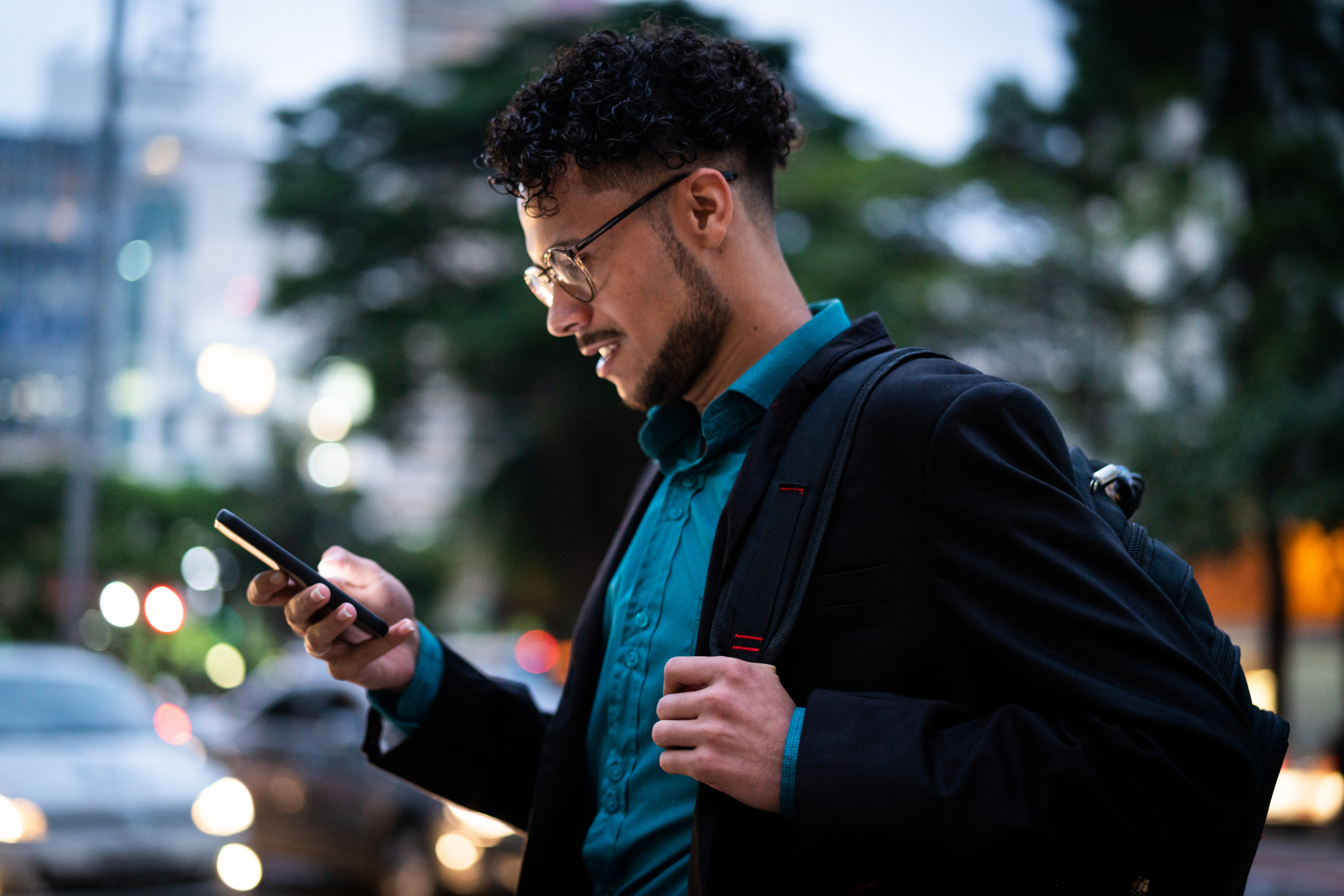 Man using phone at night outside